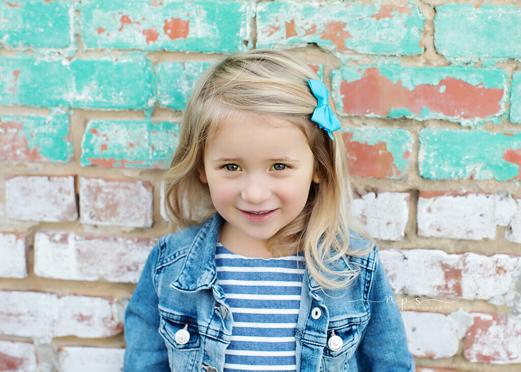 Little Girl with Brick Wall