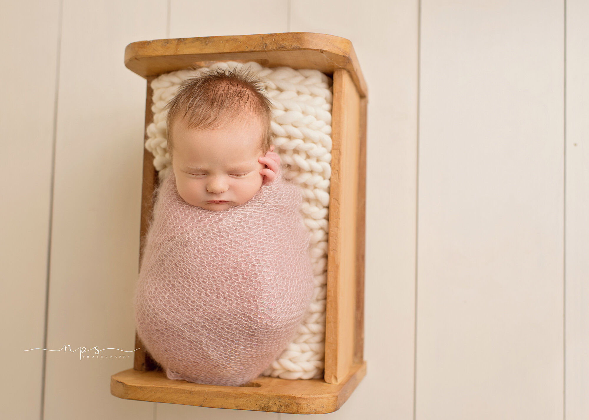 newborn in original photoblocks bed