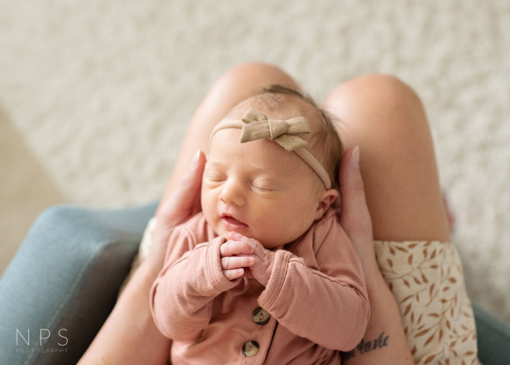newborn girl in moms hands