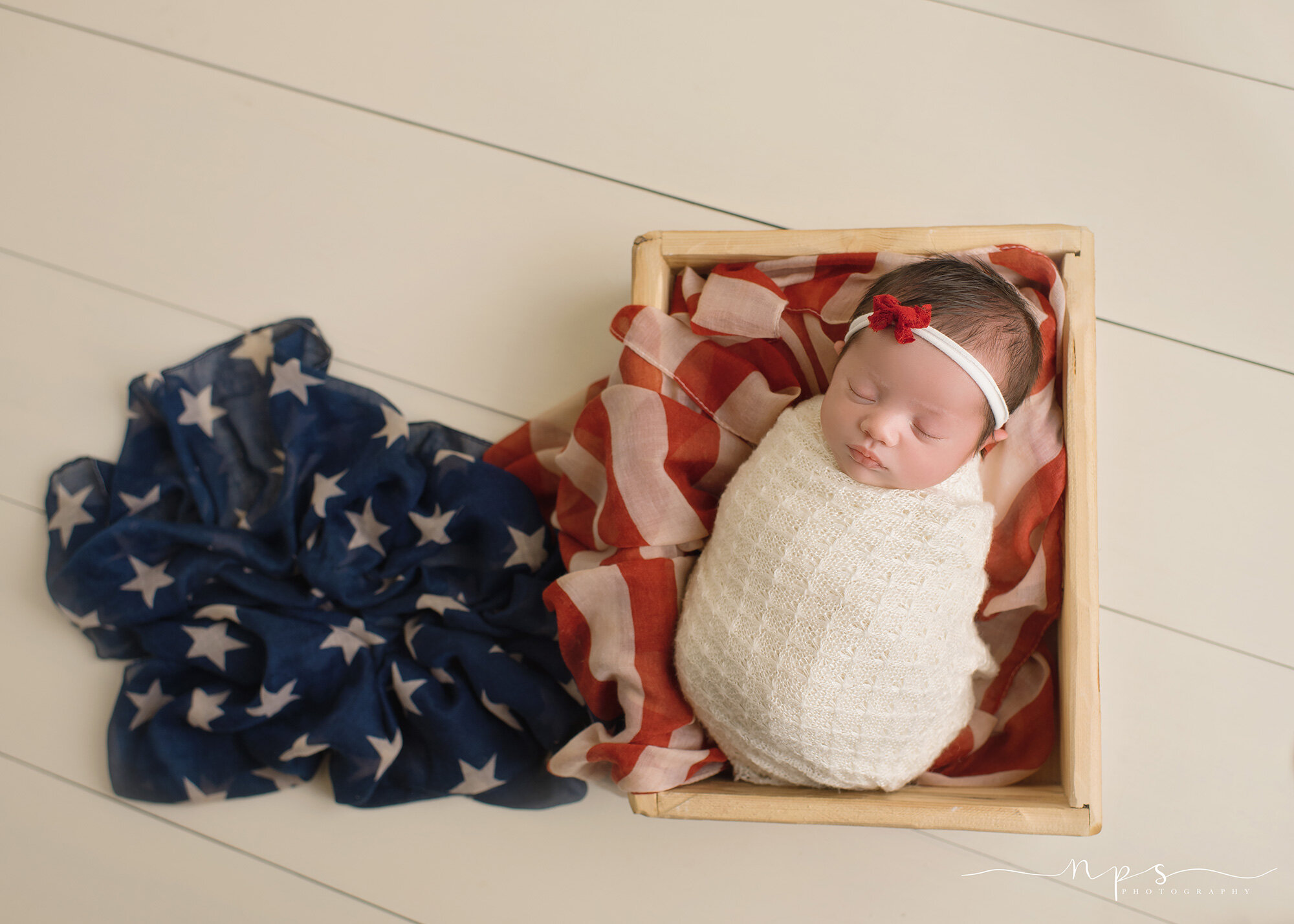 military child wrapped in flag scarf