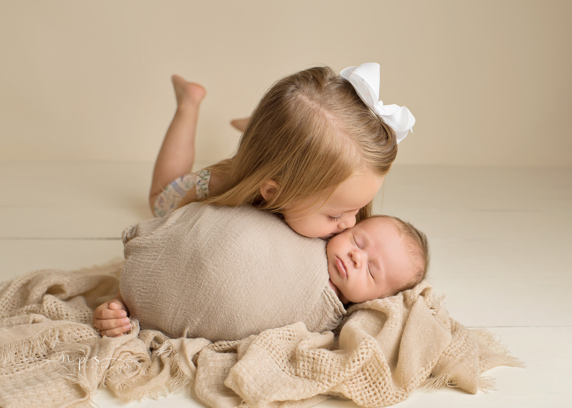 Big Sister kissing newborn