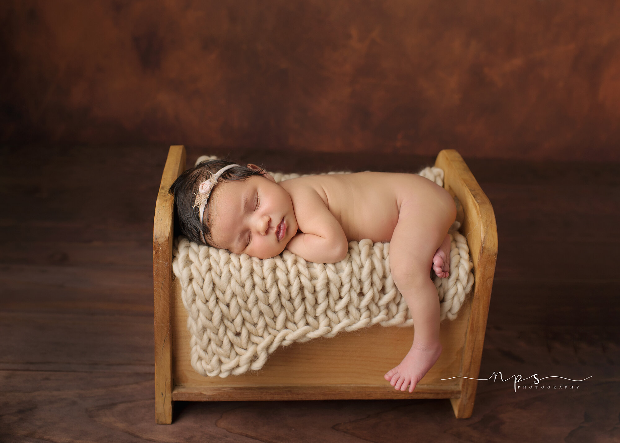 newborn in original photoblocks bed