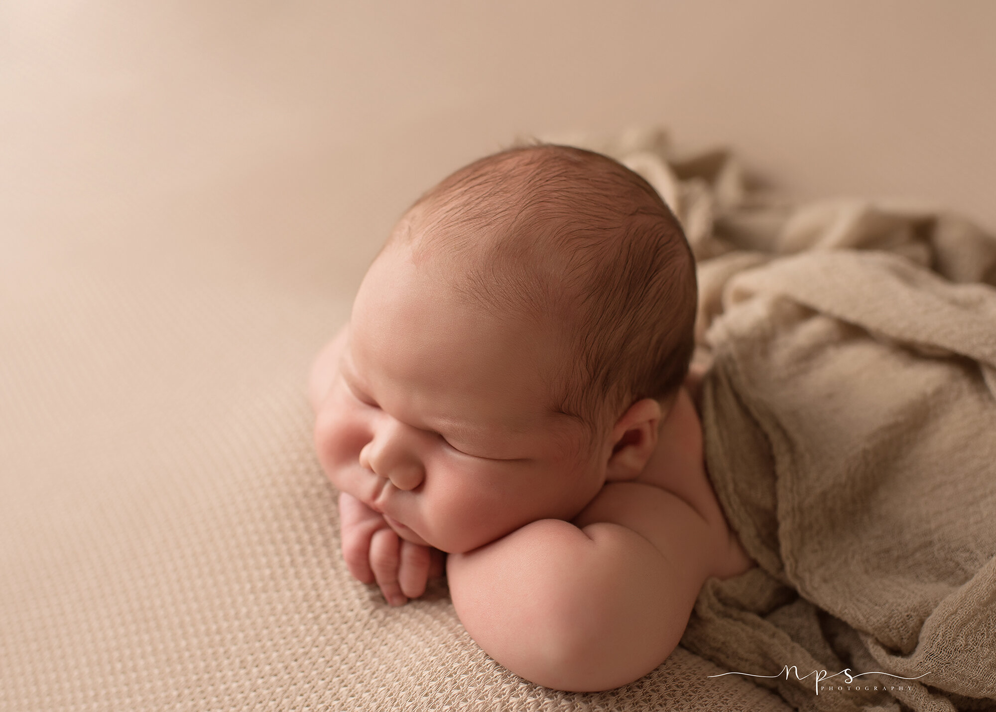 newborn head in hands pose