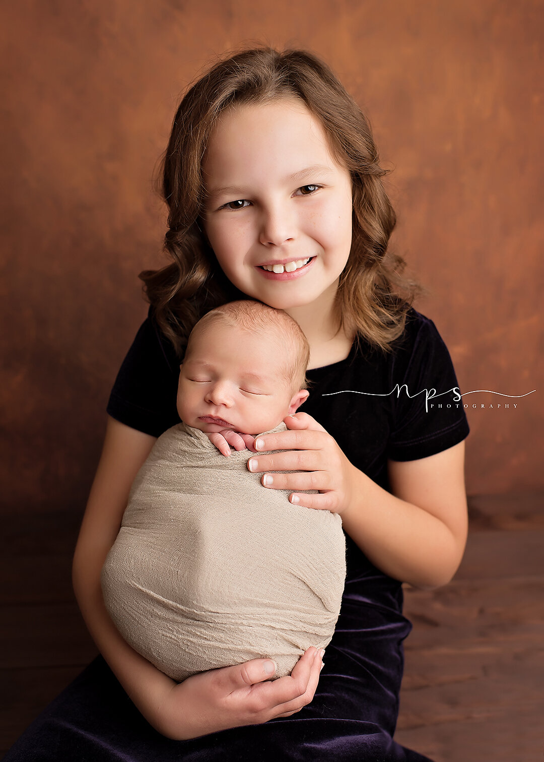 big sister and newborn in potato sack