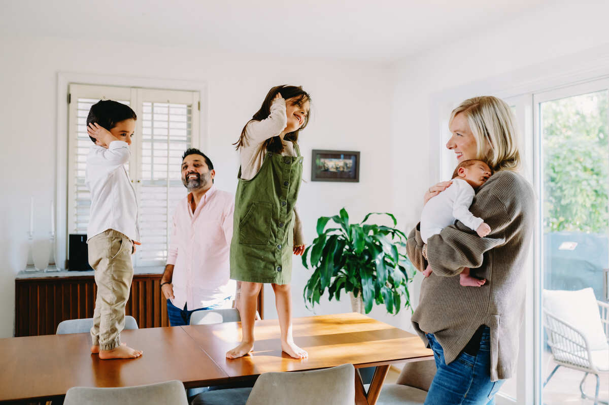 Why Parents Should Be in Family Photos | DC In-Home Photographer - NPS Photography parents playing with kids in a dining room