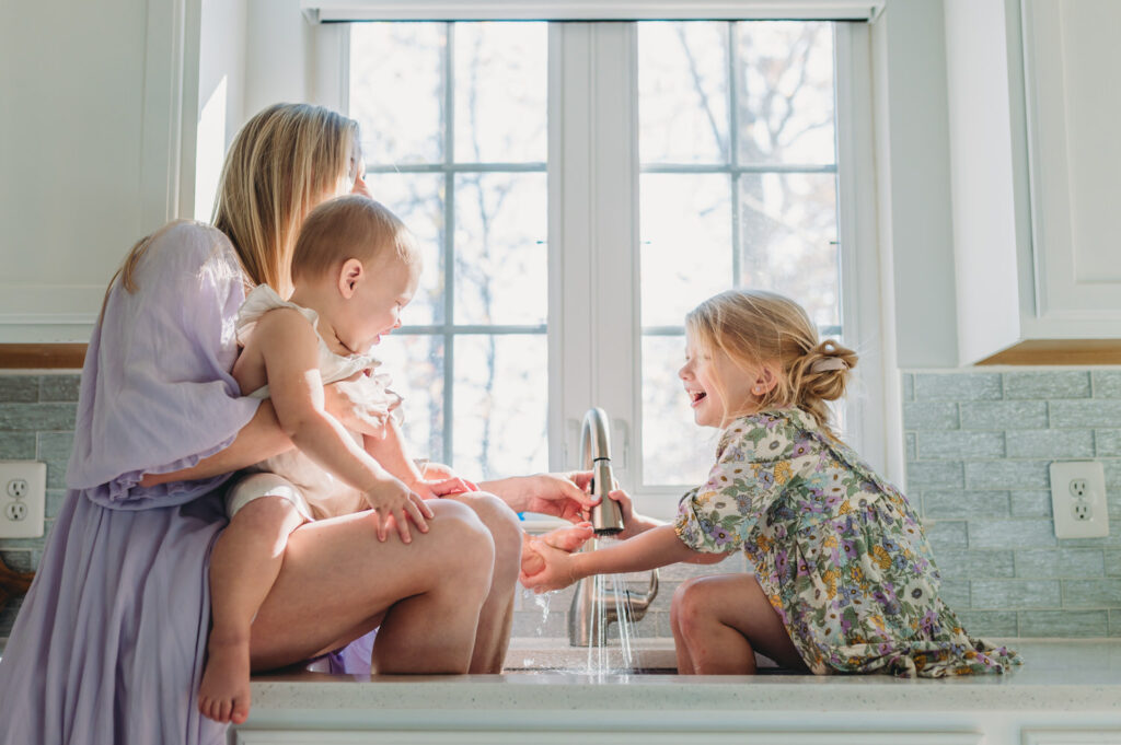 DC mom and two daughters playing with water in kitchen