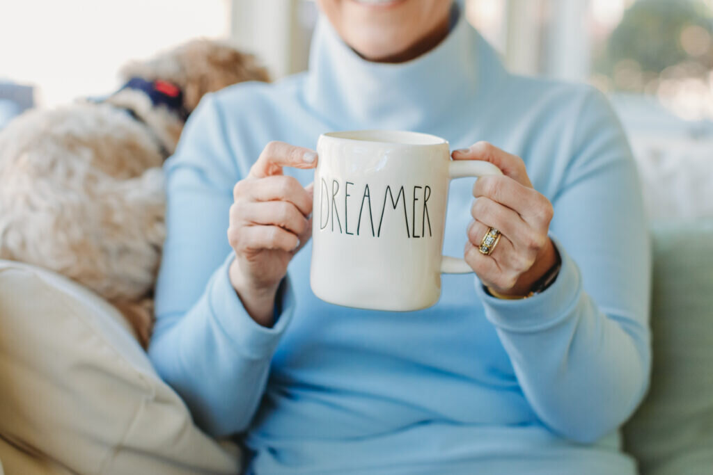 woman holding dreamer mug