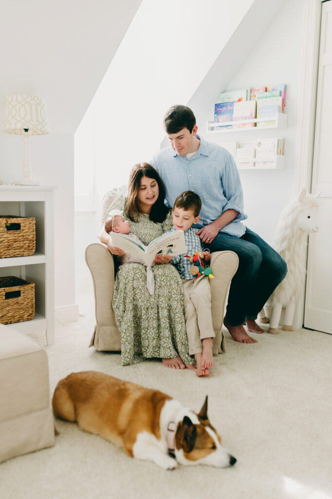 pullback of family of four in a nursery with a Corgie on the floor photographed by NPS Photography