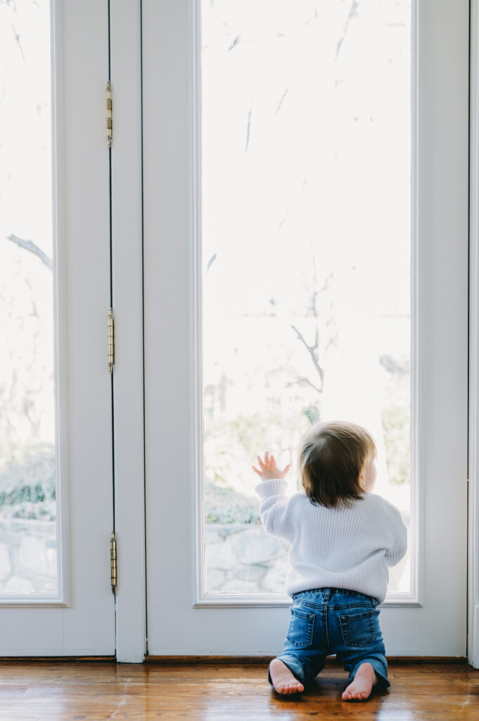 toddler kneeling in front of glass doors Bethesda, MD