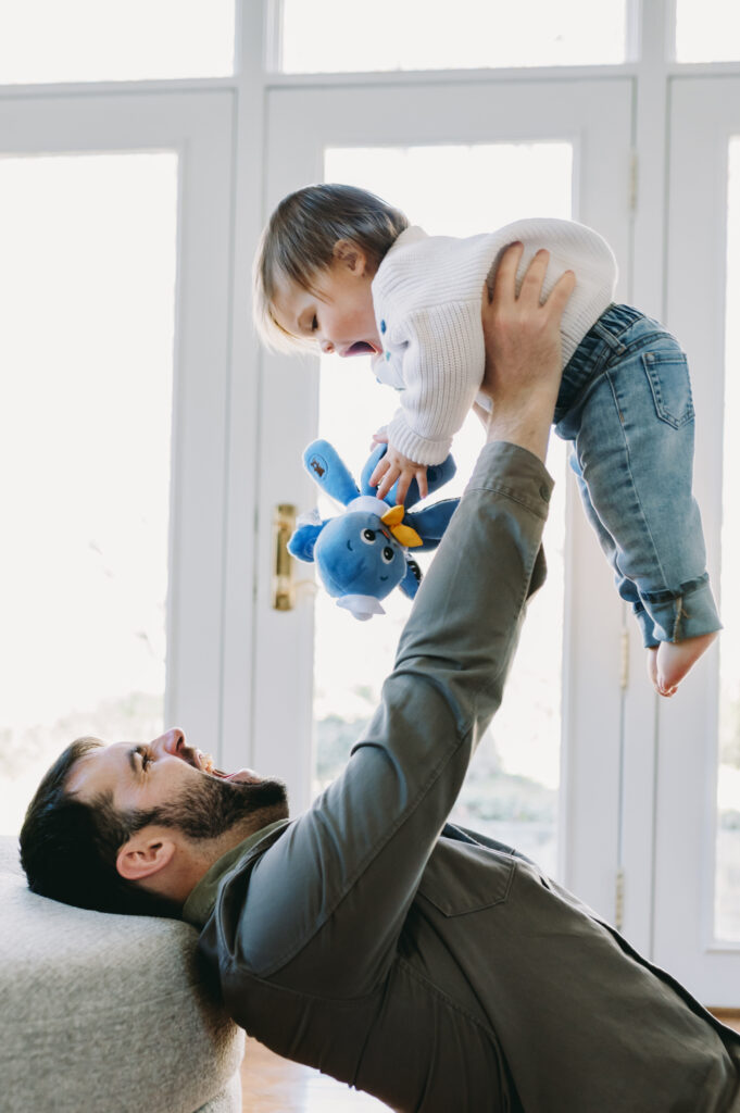dad lifting baby up in the air