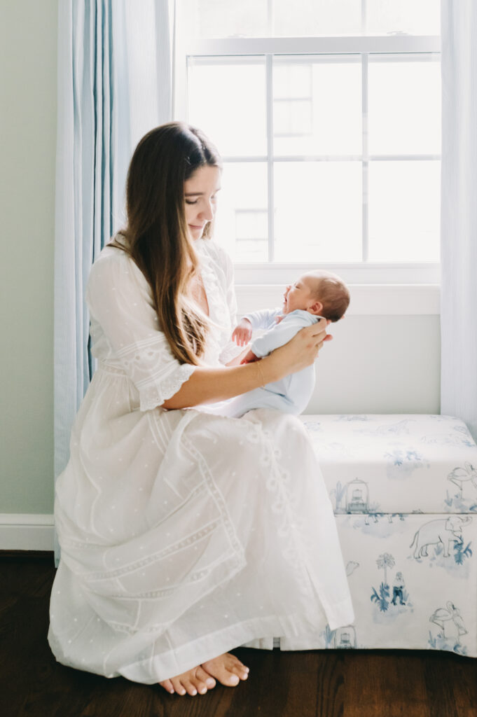 blue, white and green nursery with mom and newborn