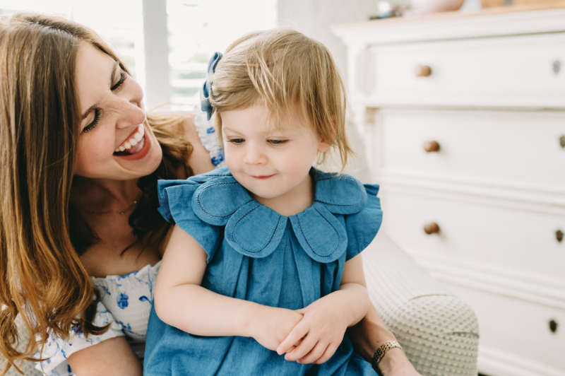 little girl in blue with her mom during a family photo shoot tips