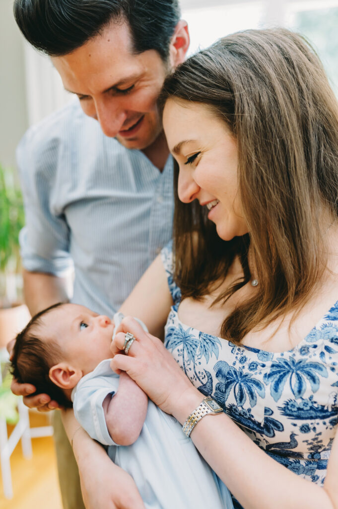 Luxury Family Photographer Pricing: You Are Not Your Client’s Budget Coach - NPS Photography mom giving baby boy a pacifier with dad looking at baby