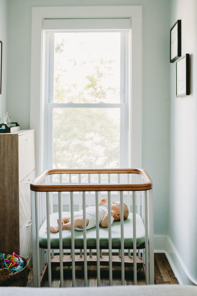 Yes, I'm Still Your Washington DC Family Photographer —Here’s the Scoop - NPS Photography newborn baby in a crib in front of a window