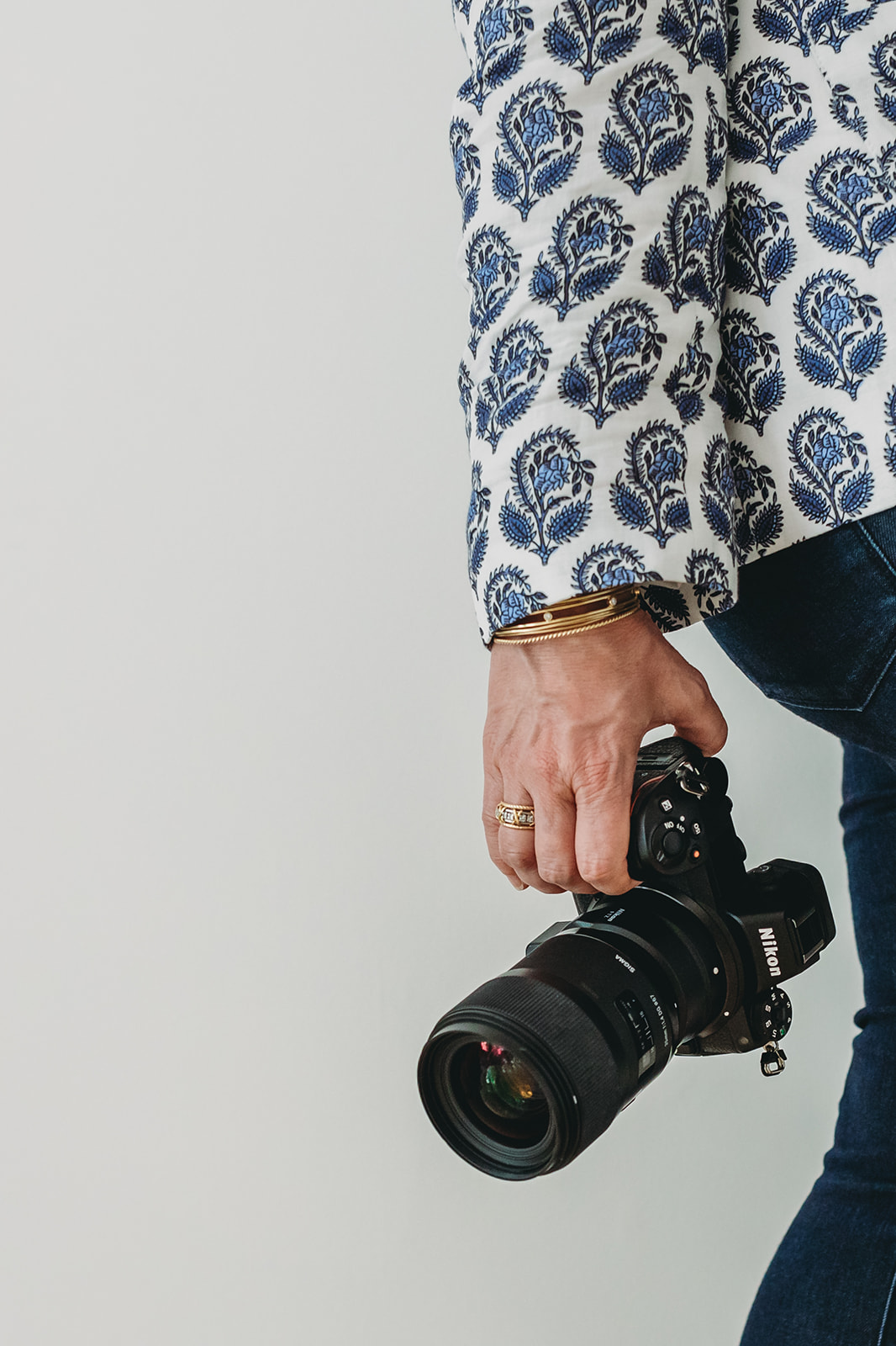 Photographer holding a camera by their side—an authentic touch to feature on your contact page.