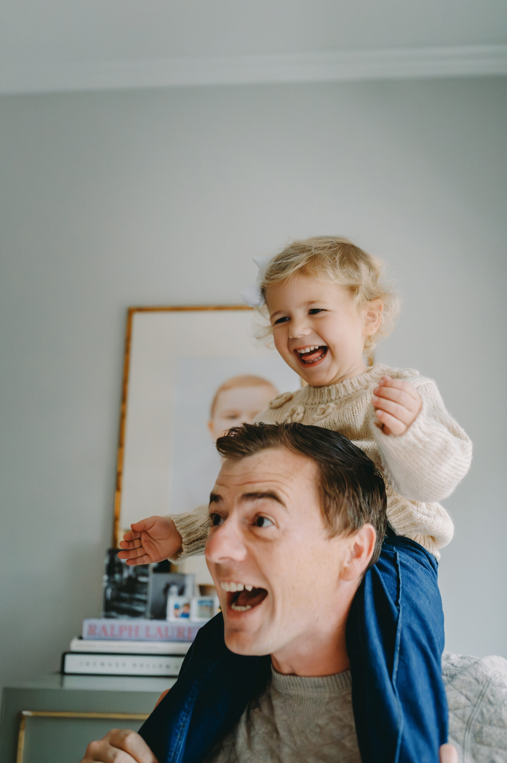 photography-client-pain-points dad giving his daughter shoulder rides, belly laughs, and a bond full of joy- photography client pain points