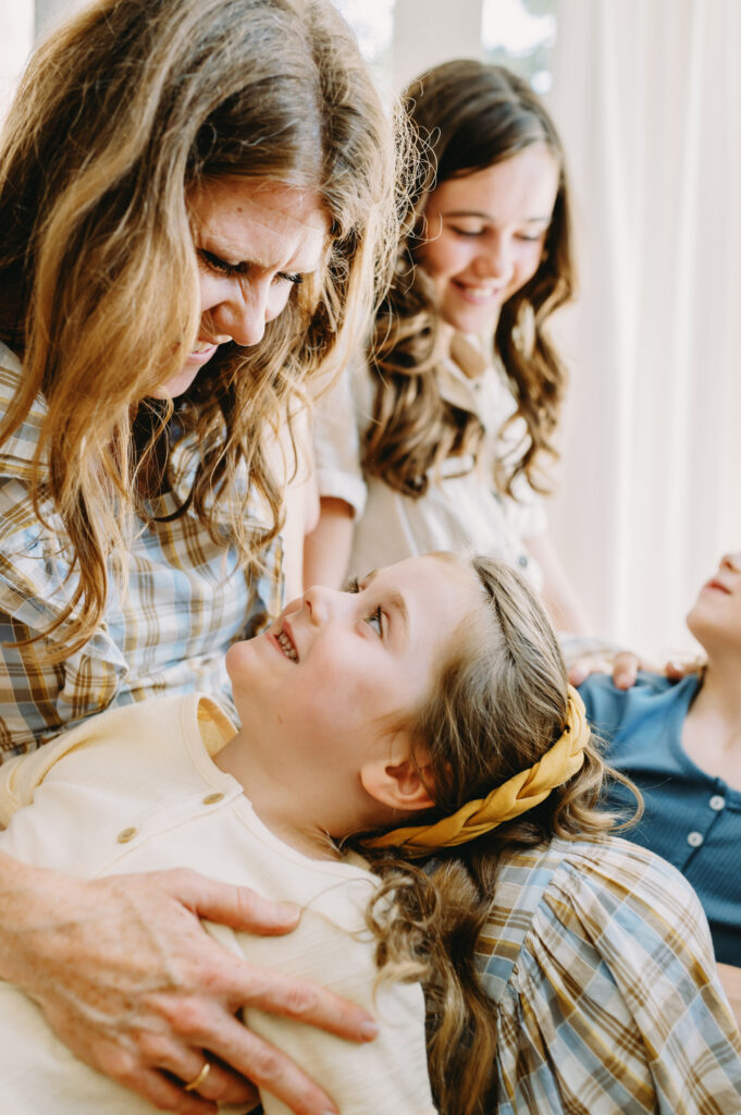 photography-prompts-for-kids A warm family moment with mom and kids smiling, brought to life using gentle photography prompts for kids.