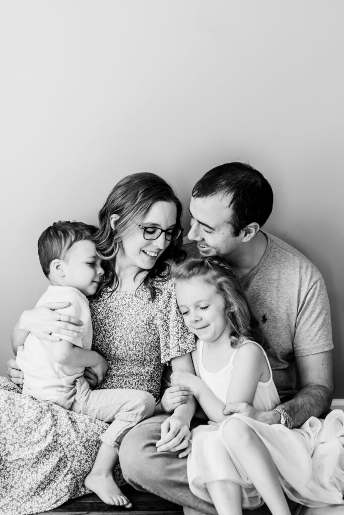 photography-prompts-for-kids A loving family shares a tender moment on the floor, beautifully captured using thoughtful photography prompts for kids.
