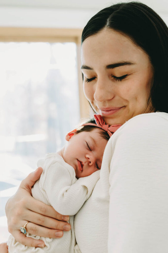 Newborn photo by Arlington, VA Photographer - mom snuggling baby girl