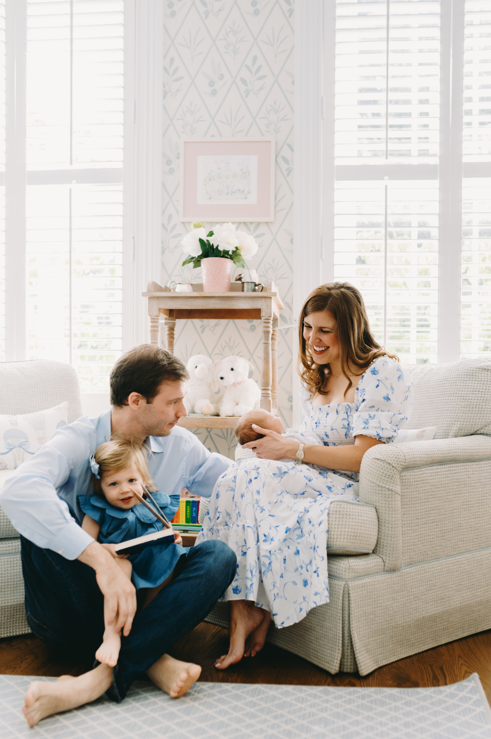 Lifestyle Newborn Session vs. Studio: Which One Fits Your Family Best? - NPS Photography Family of four playing and bonding in the nursery during a light-filled lifestyle newborn session with older sibling smiling.