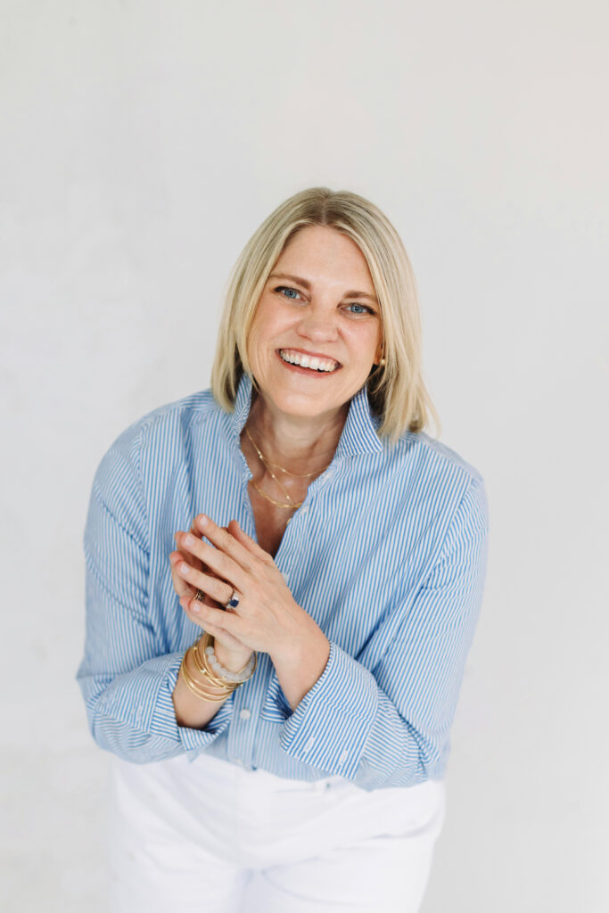 Photographer smiling confidently, representing how to simplify your photography business with joy and clarity.