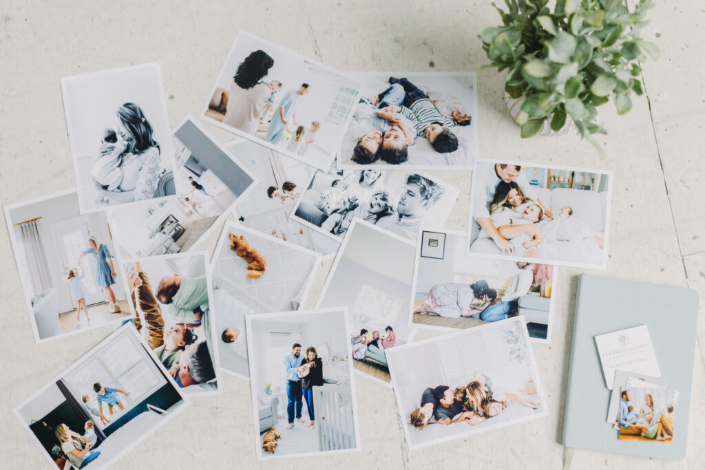 Tips for Photographers for a Profitable Holiday Season - NPS Photography A flat lay of printed family photos and business cards, illustrating tips for photographers on showcasing client work and offering seasonal products.