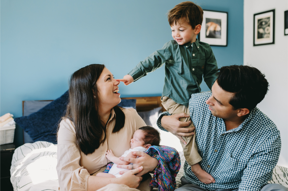 What Is Storytelling Photography? The Heartfelt Secret to Capturing Your Family’s Most Meaningful Moments - NPS Photography A big brother proudly booping his mom’s nose as she holds the new baby, while dad wraps his arms around them — a moment that shows connection, chaos, and pure joy all at once.