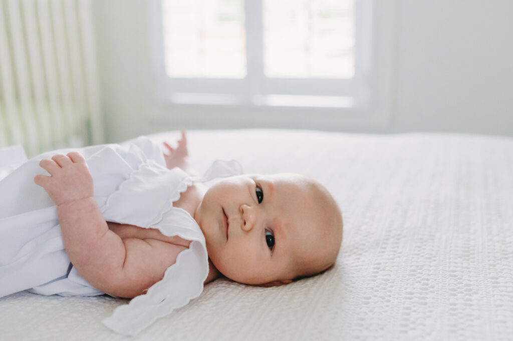 What Is Storytelling Photography? The Heartfelt Secret to Capturing Your Family’s Most Meaningful Moments - NPS Photography Newborn baby lying on a bed in soft natural light, demonstrating what is storytelling photography through simple, meaningful details.