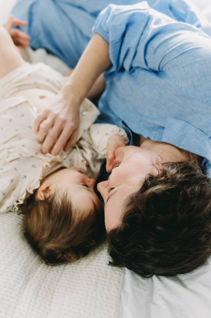 mom snuggling little girl in their Glen Echo, MD home